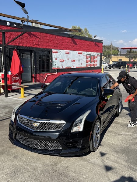 Hand wash in progress at Miracle Mile Carwash